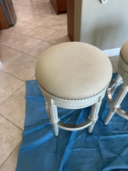 A clean off-white stool chair.