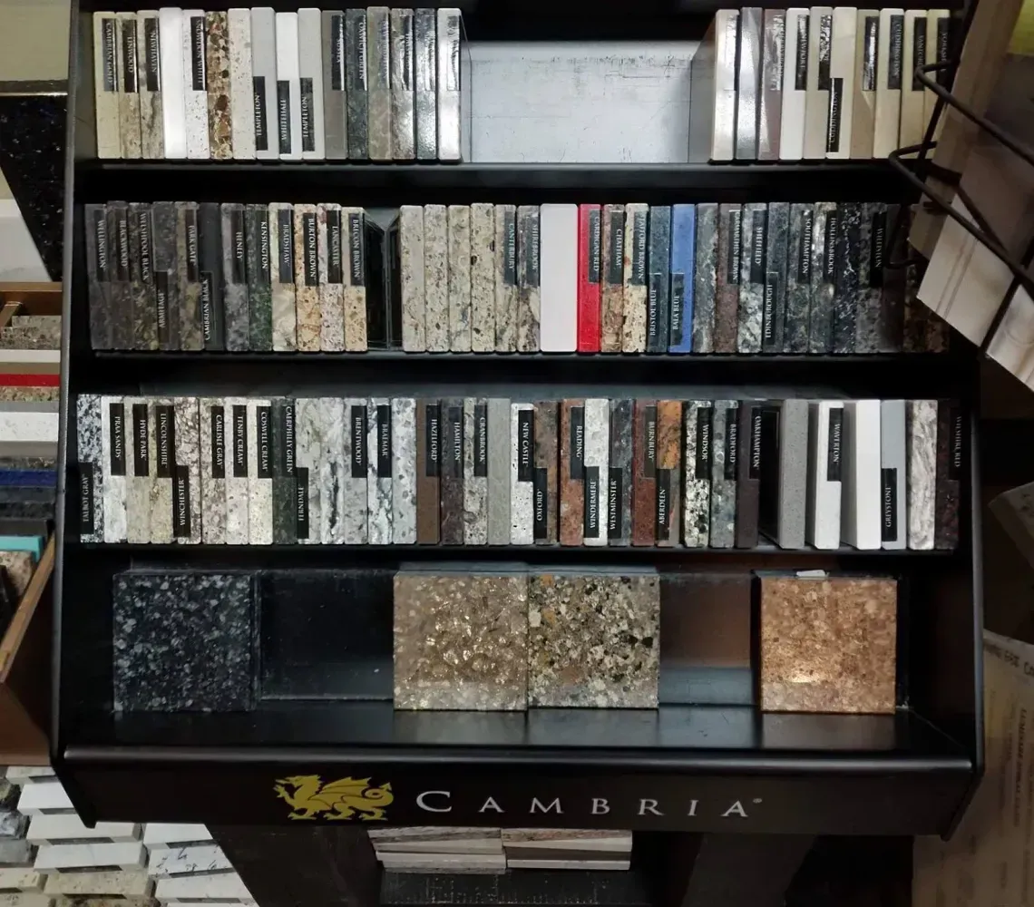 Shelved Cambria countertop display with rows of color and stone sample tiles