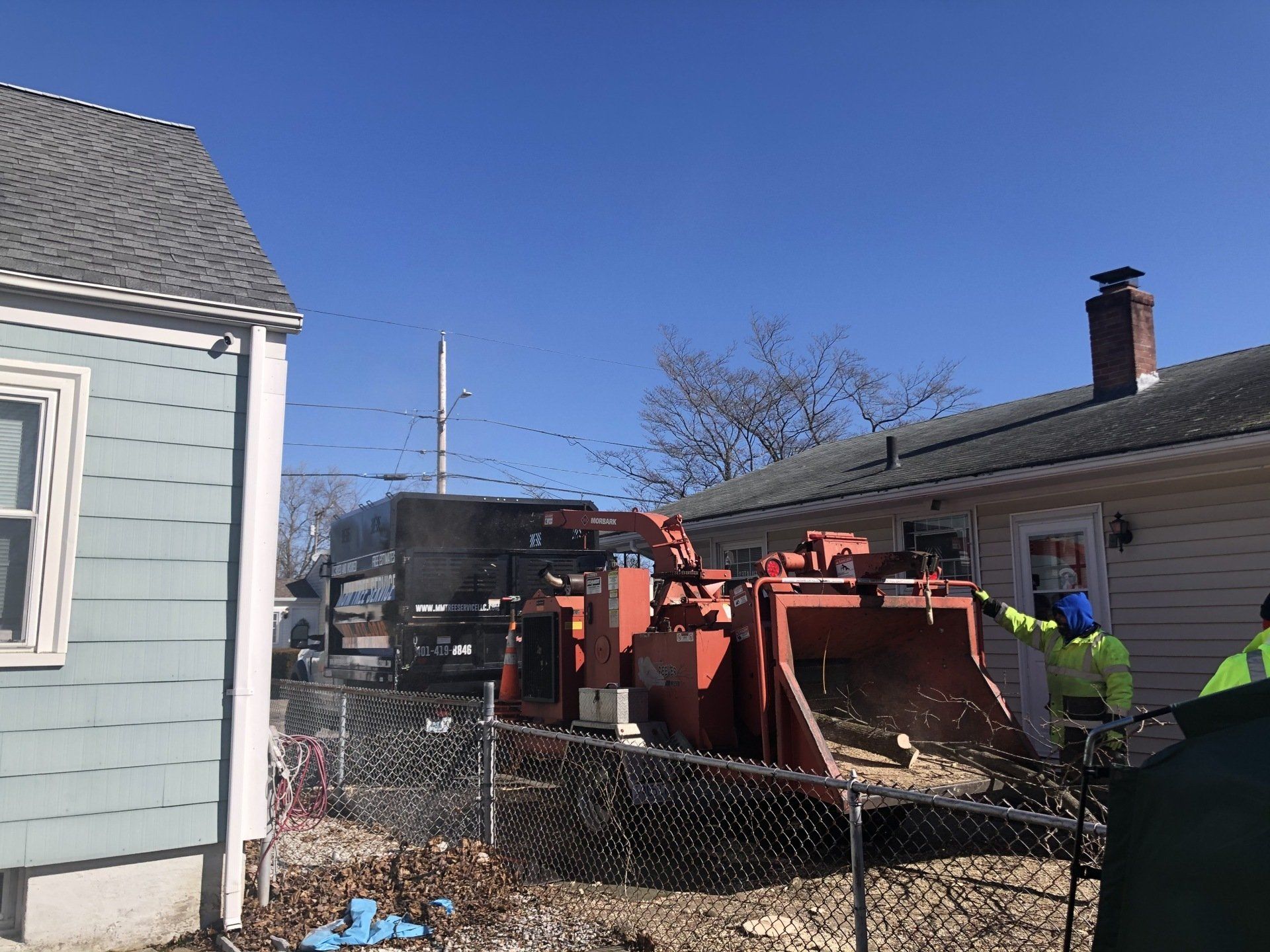 M&M Tree service truck chipping tree down