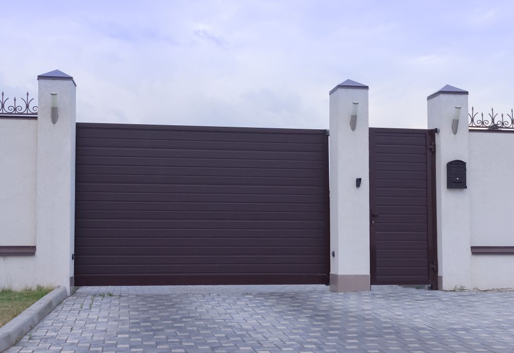 Brown Metal Sliding Gate With a Smaller Matching Pedestrian Gate — All Around Concreting in Byron Bay, NSW
