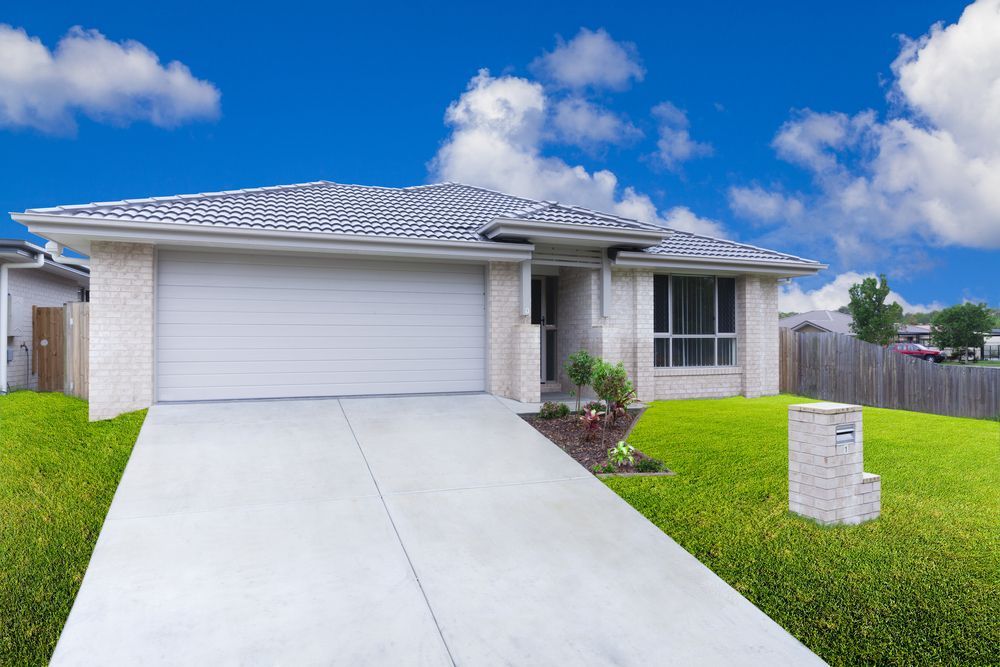 Modern House With Gray Roof and Garage Door, Light Brick Exterior — All Around Concreting in Lennox Head, NSW
