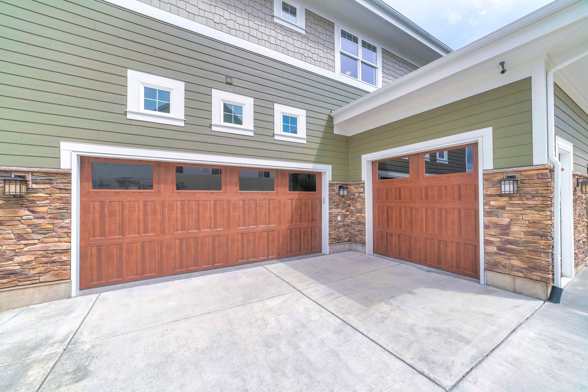 Two Brown Garage Doors, One Open, on a Concrete Driveway — All Around Concreting in Byron Bay, NSW