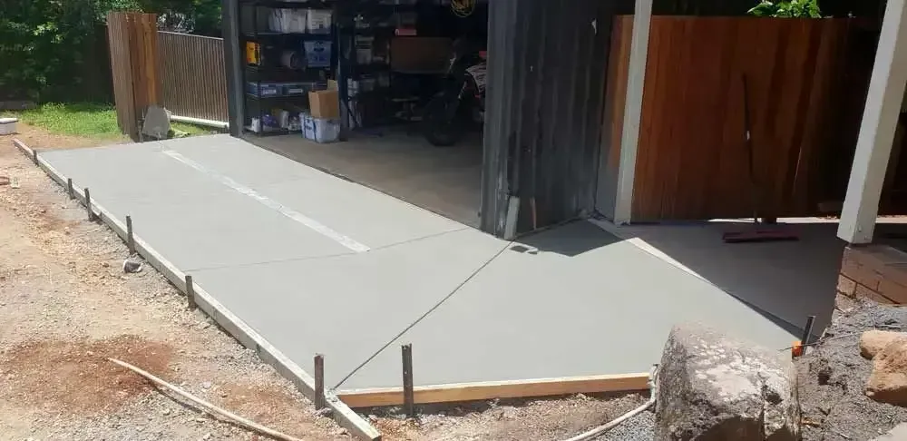 Freshly Poured Concrete Driveway in Front of a Garage — All Around Concreting in Wollongbar, NSW