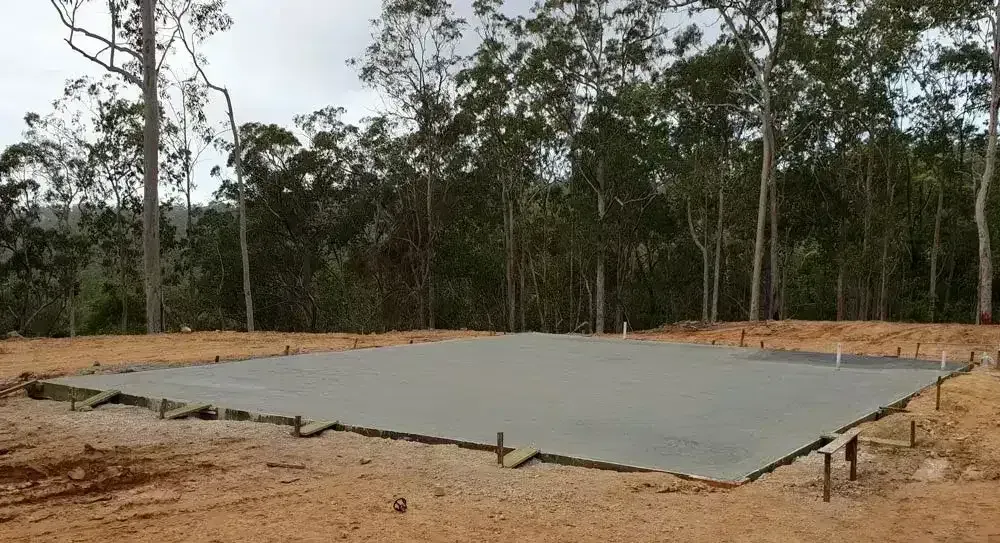 Concrete Slab Foundation on Dirt Lot With Trees in Background — All Around Concreting in Wollongbar, NSW