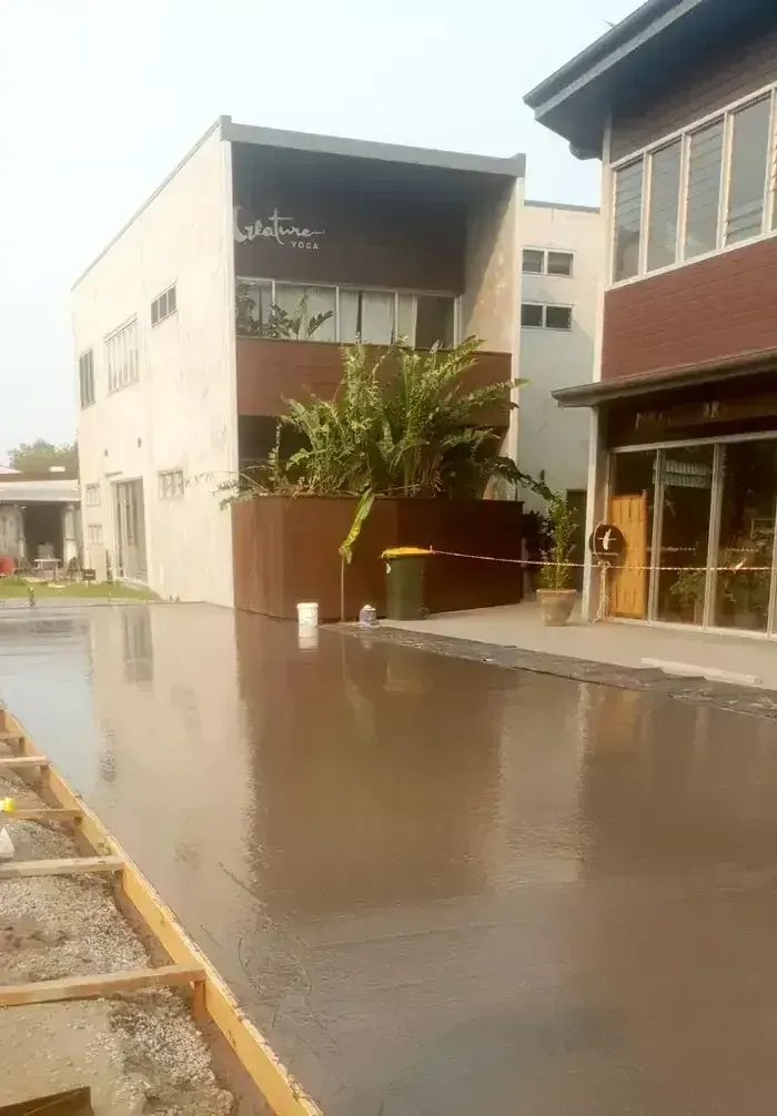 Newly Poured Concrete Surface in Front of Buildings — All Around Concreting in Wollongbar, NSW