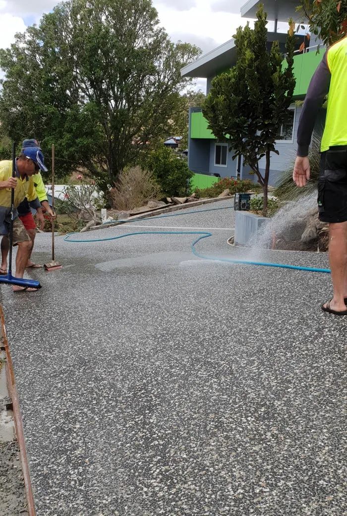 Two Workers Cleaning a Concrete Surface With Water — All Around Concreting in Wollongbar, NSW