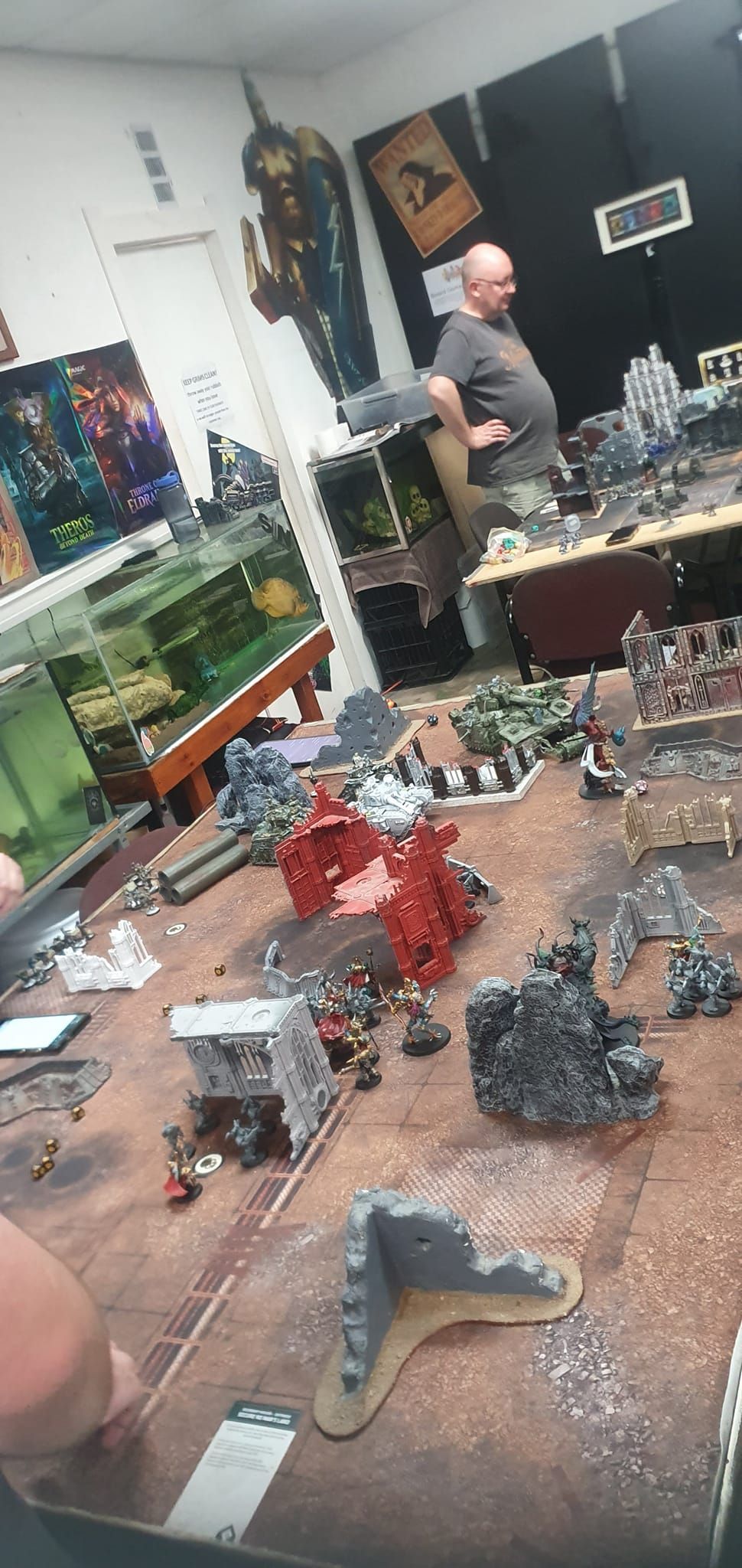 A Person Observes a Tabletop Game With Miniature Figures and Terrain — Grim Gaming & Hobbies in Bundaberg Central, QLD