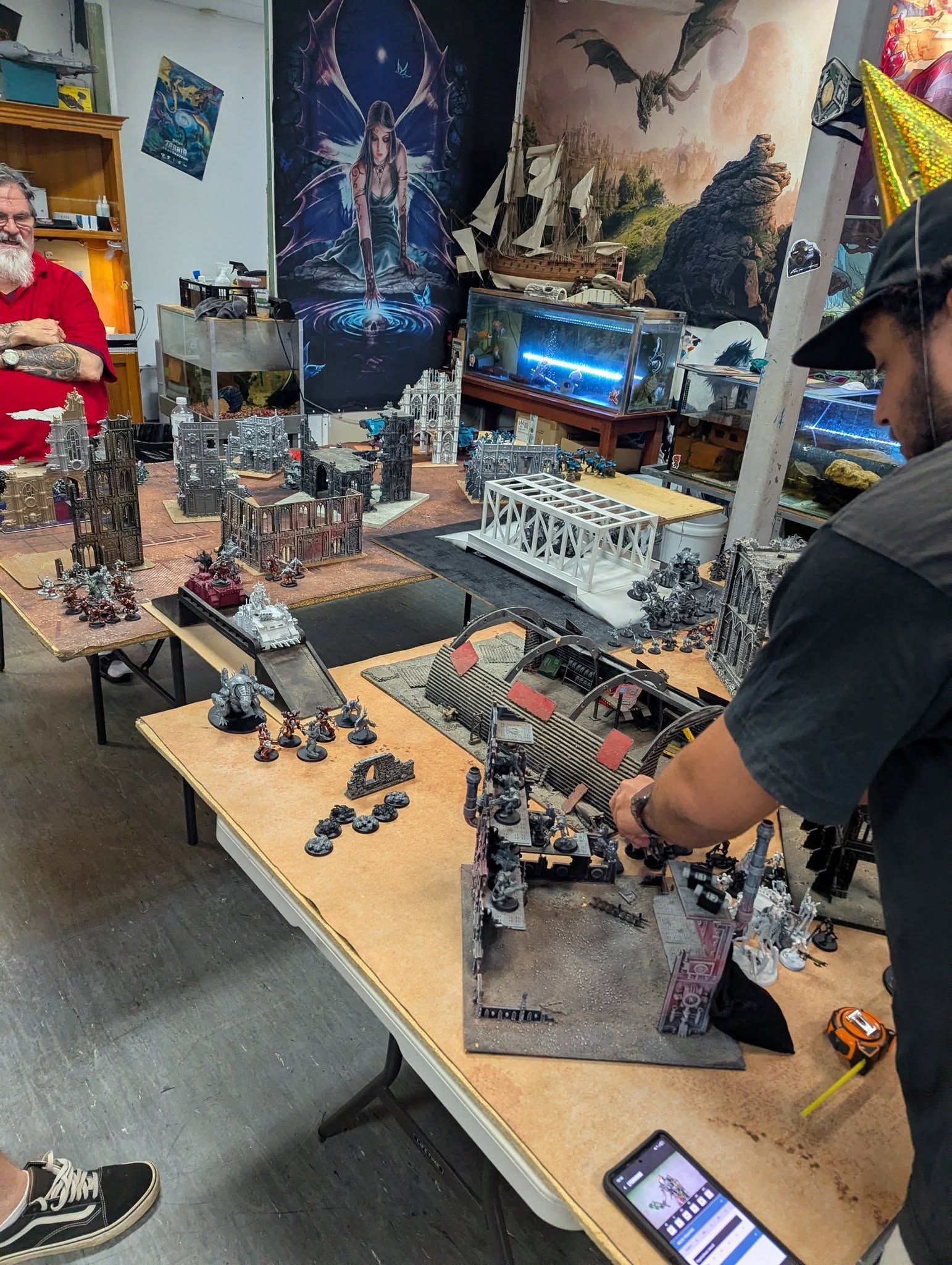 Men Playing Tabletop War Game With Miniatures, Elaborate Terrain, in a Shop — Grim Gaming & Hobbies in Bundaberg Central, QLD