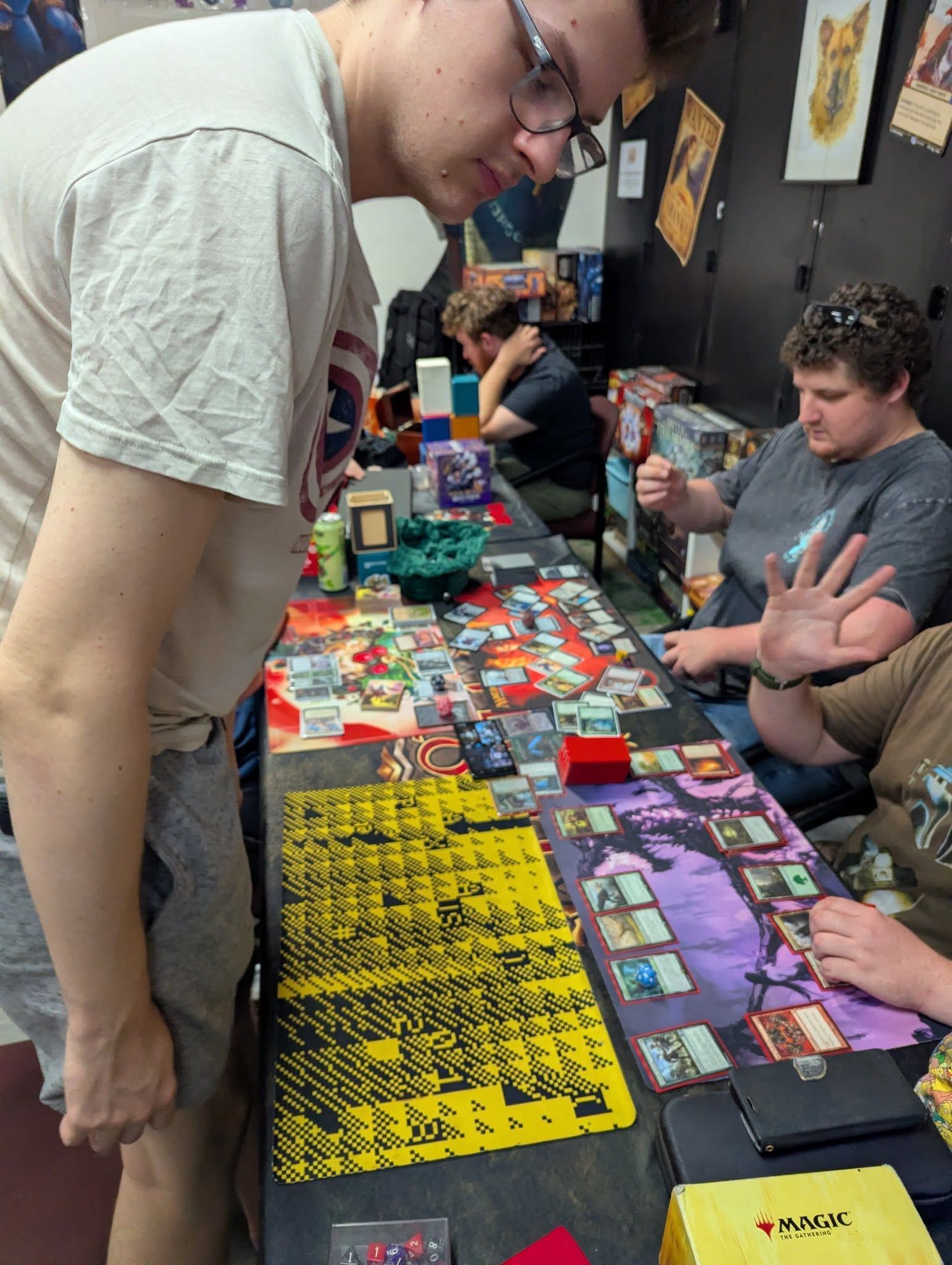 People Playing a Board Game at a Table — Grim Gaming & Hobbies in Bundaberg Central, QLD
