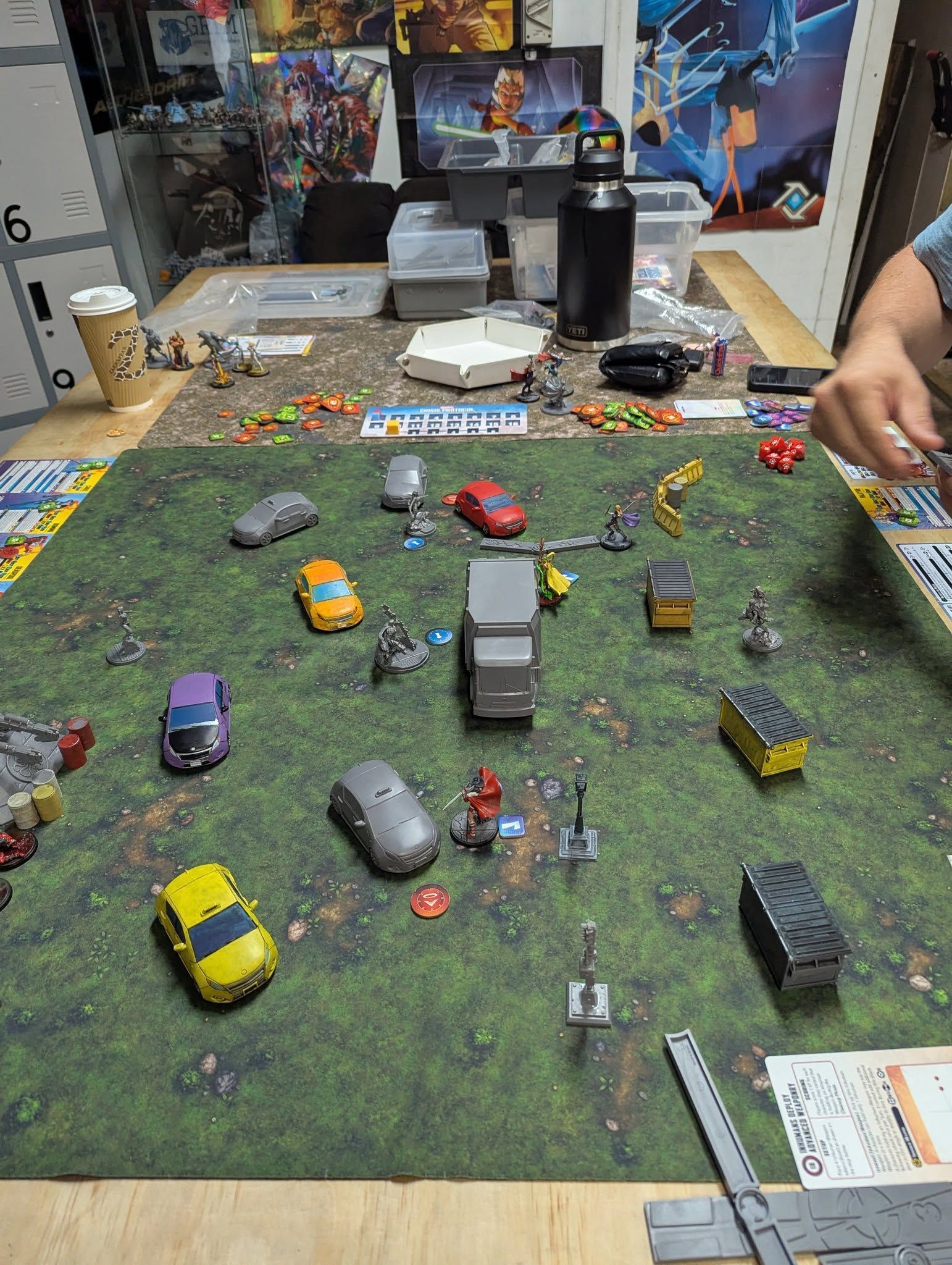 A Tabletop Game With Toy Vehicles and Figures on a Green Mat — Grim Gaming & Hobbies in Bundaberg Central, QLD