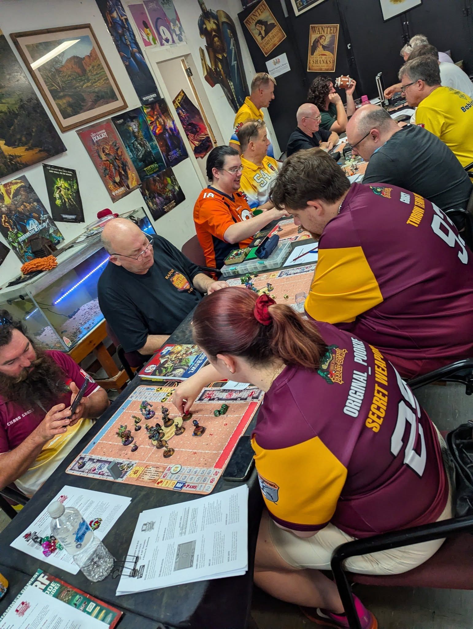 People Playing Board Game at a Table Room With Posters — Grim Gaming & Hobbies in Bundaberg Central, QLD
