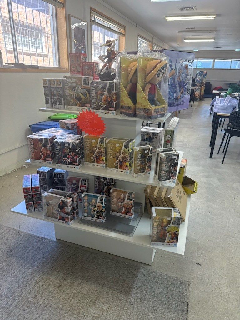 Shelves Displaying Action Figures and Toys for Sale in a Store — Grim Gaming & Hobbies in Bundaberg Central, QLD