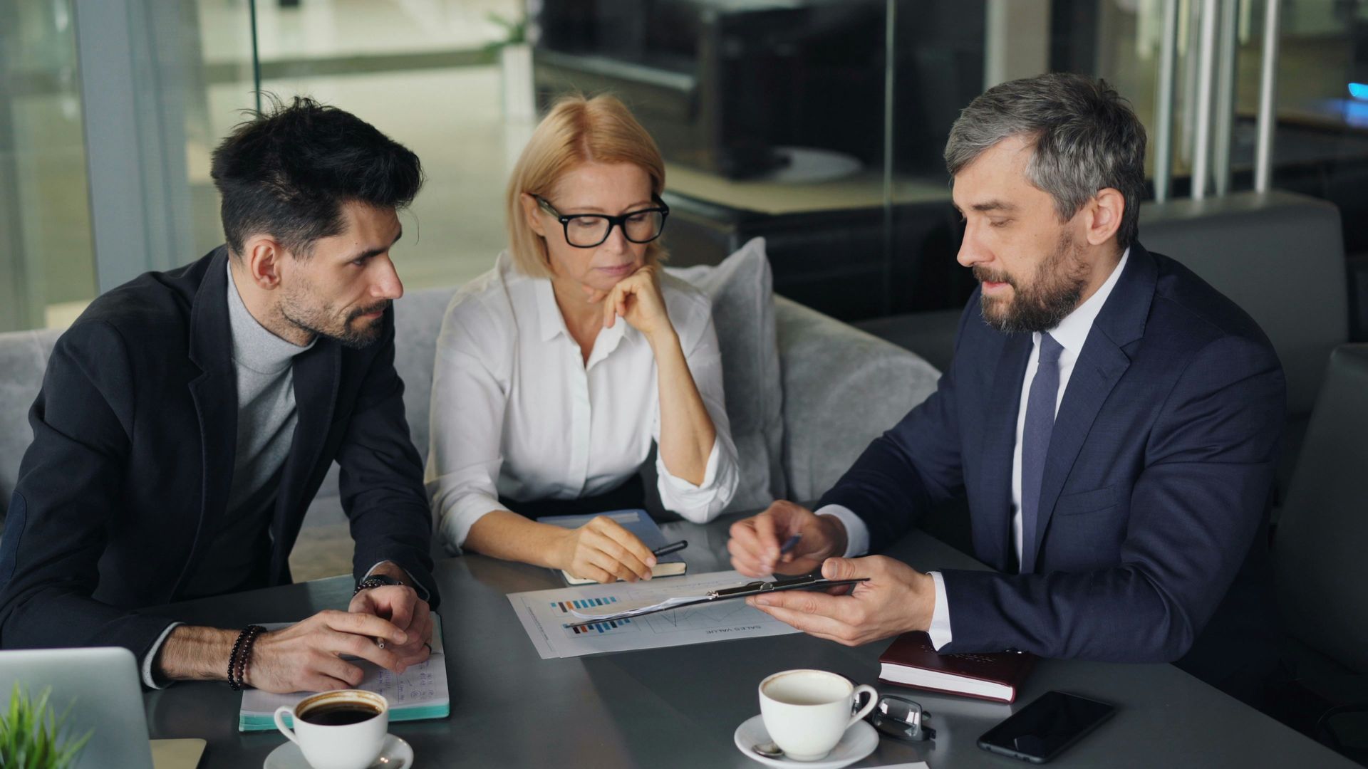 Business owners discussing retirement planning with a financial adviser.