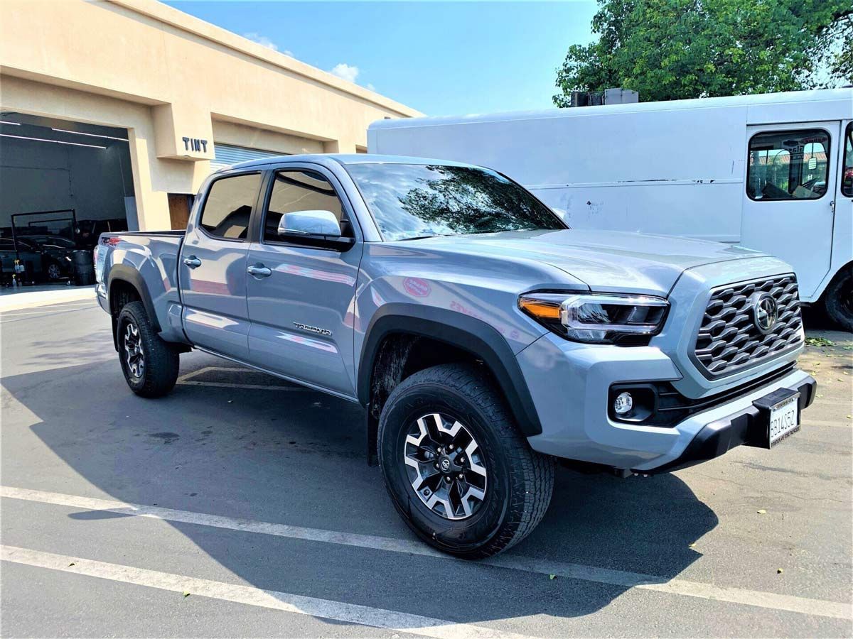 A silver truck is parked in a parking lot
