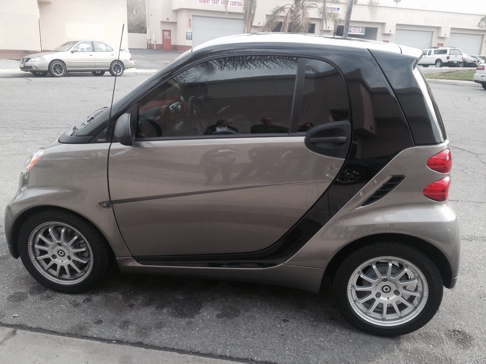 A small car is parked on the side of the road