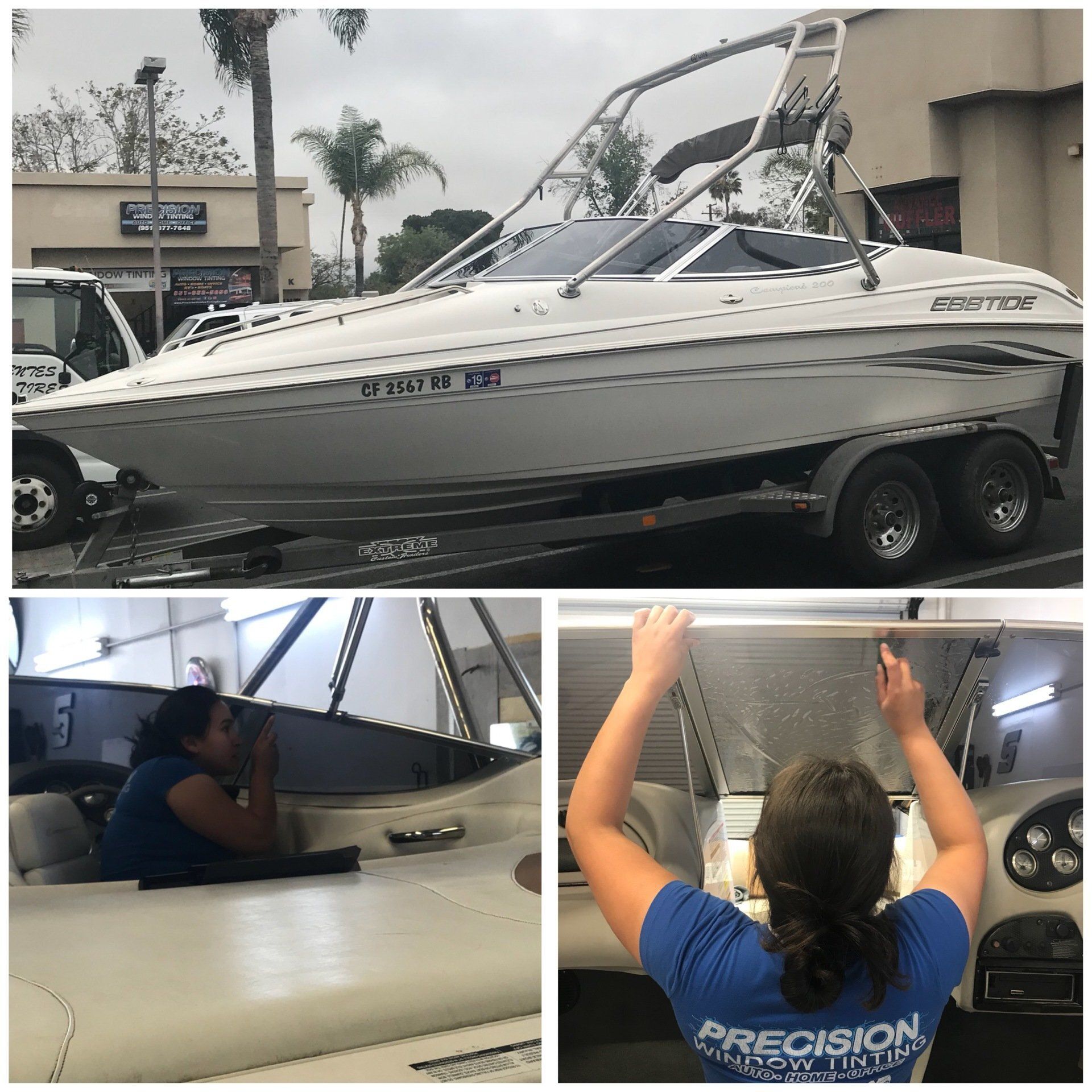 A woman in a blue shirt with the word precision on the back is working on a boat