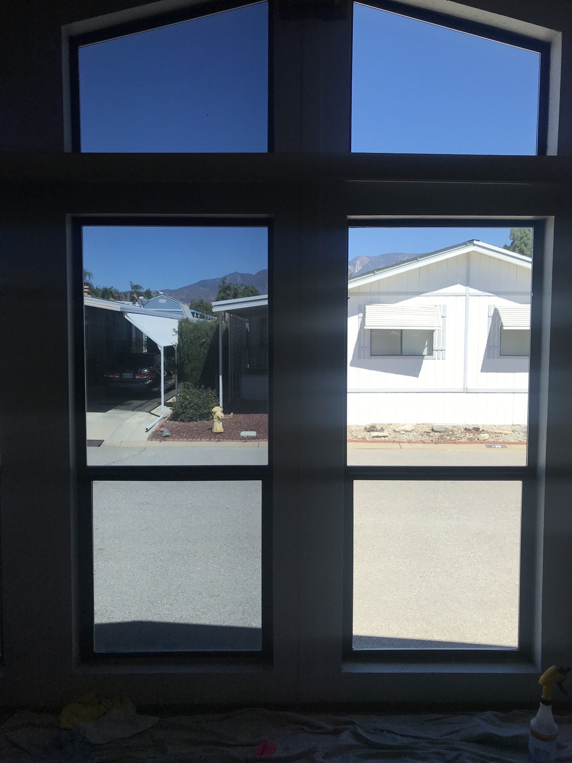 A house is reflected in the windows of a building