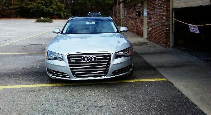 A silver audi is parked in a parking lot