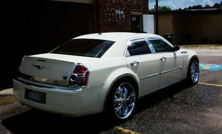 A white car is parked in a handicapped parking spot