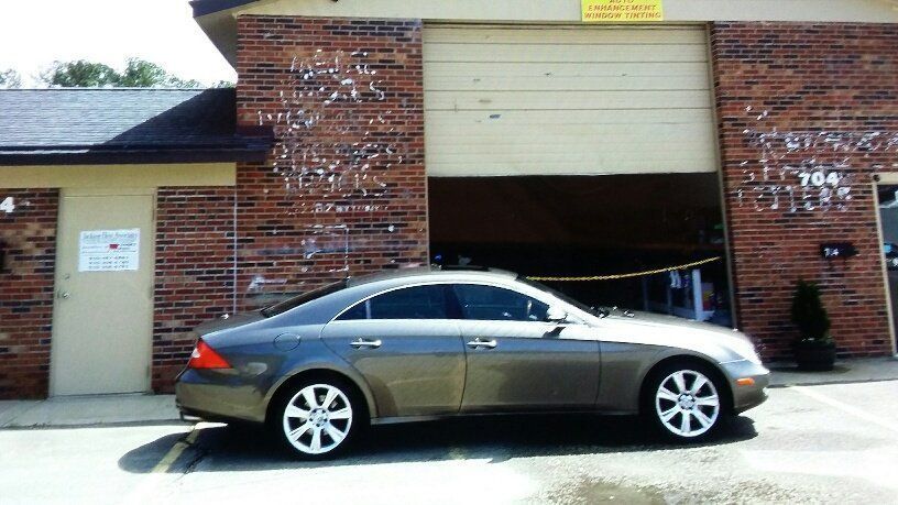 A car is parked in front of a brick building