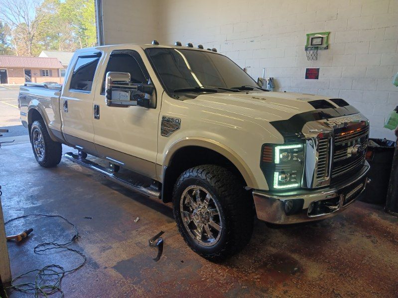 A white pickup truck is parked in a garage.