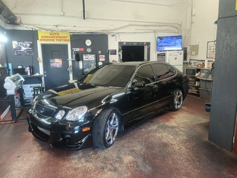 A black car is parked in a garage.