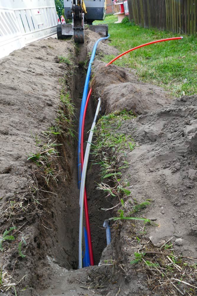 A Red, White and Blue Fibre Optic Cable Being Installed — Adzcom Civils in Innisfail, QLD