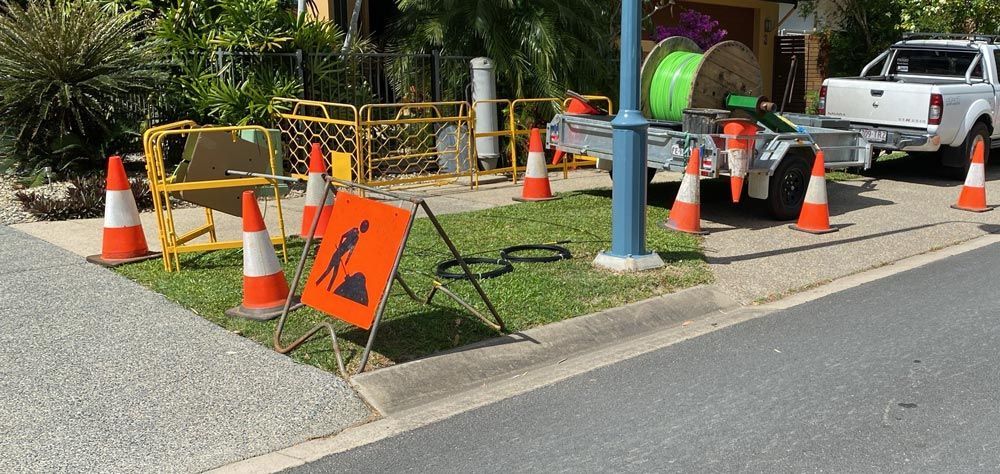 A Truck is Parked on the Side of the Road Next to a Signage and Cones — Adzcom Civils in Portsmith, QLD