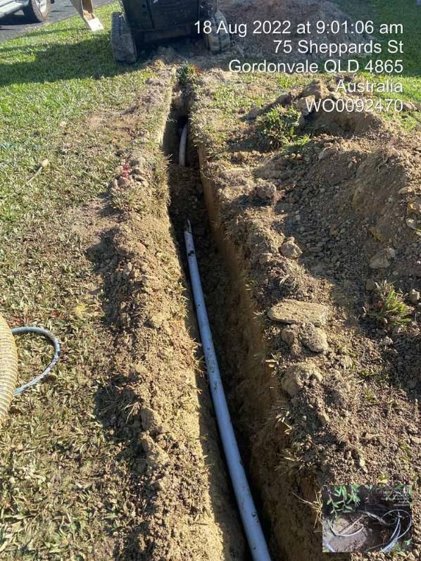 A Pipe Being Installed in a Hole in the Ground — Adzcom Civils in Portsmith, QLD