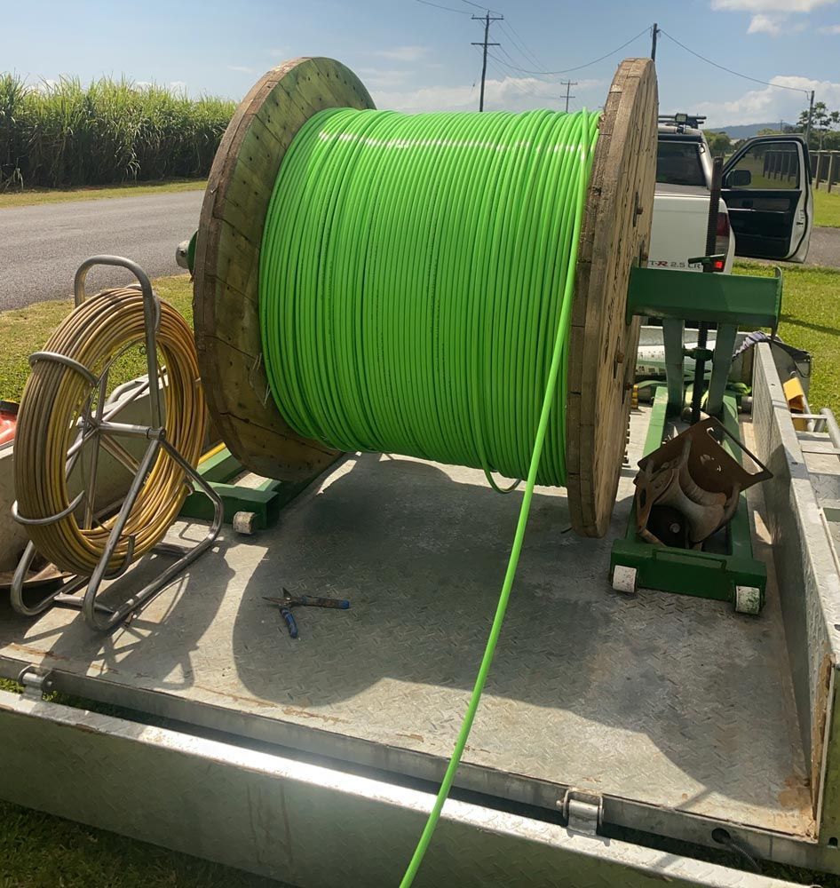 A Large Green Spool of Fibre Optic Cable — Adzcom Civils in Portsmith, QLD