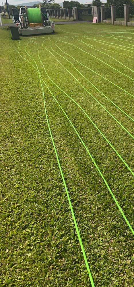 Green Fibre Optic Cables Lying on the Ground — Adzcom Civils in Port Douglas, QLD