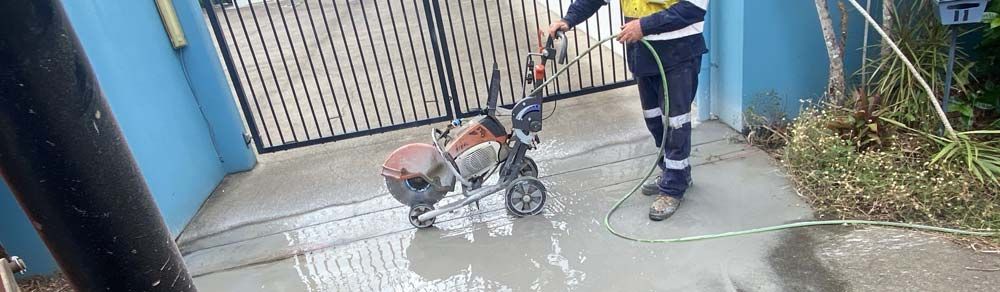 Man is Using a Concrete Saw — Adzcom Civils in Portsmith, QLD