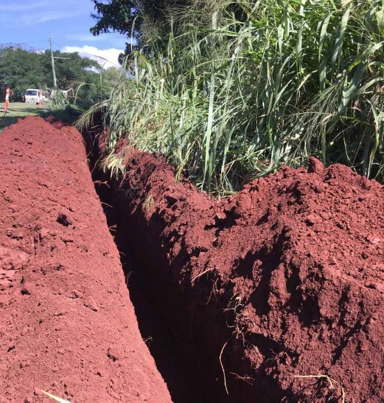A Large Pile of Dirt is in the Middle of a Field During Excavation Process — Adzcom Civils in Portsmith, QLD