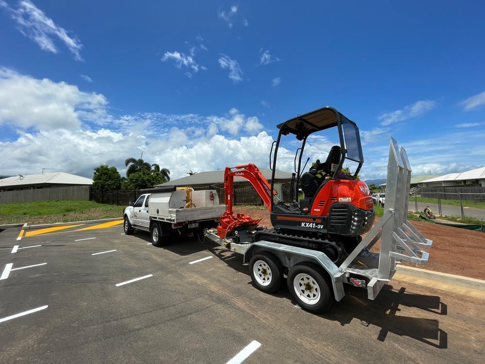 Red Excavator Being Transported — Adzcom Civils in Portsmith, QLD