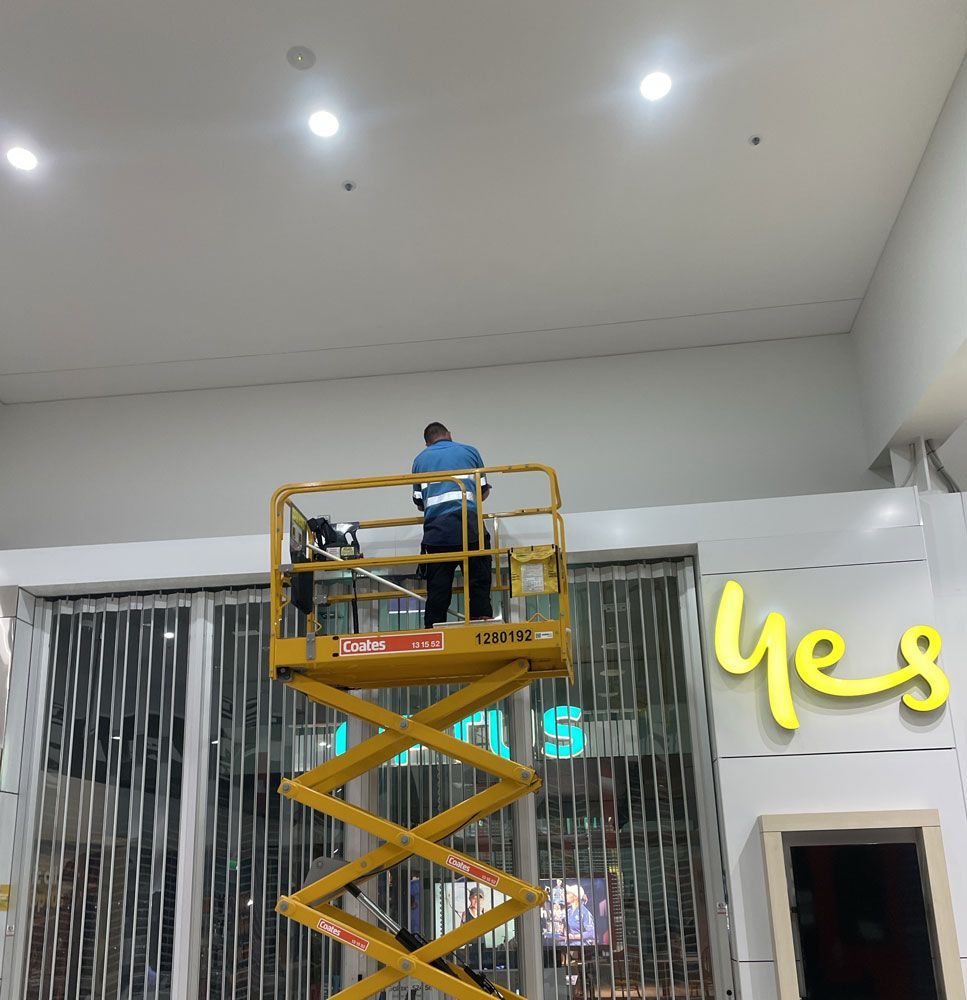 Worker Using Scissor Lift at Work — Adzcom Civils in Portsmith, QLD