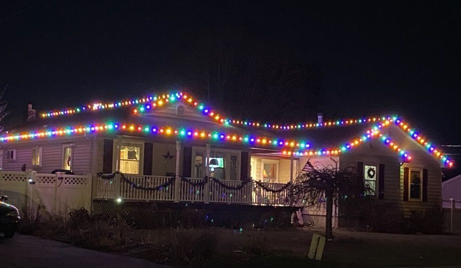 colorful christmas lighting installation on home.