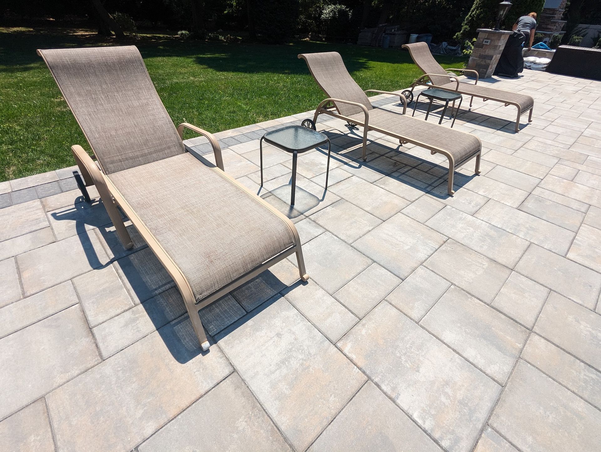 new pool tile lounging area with lawn chairs