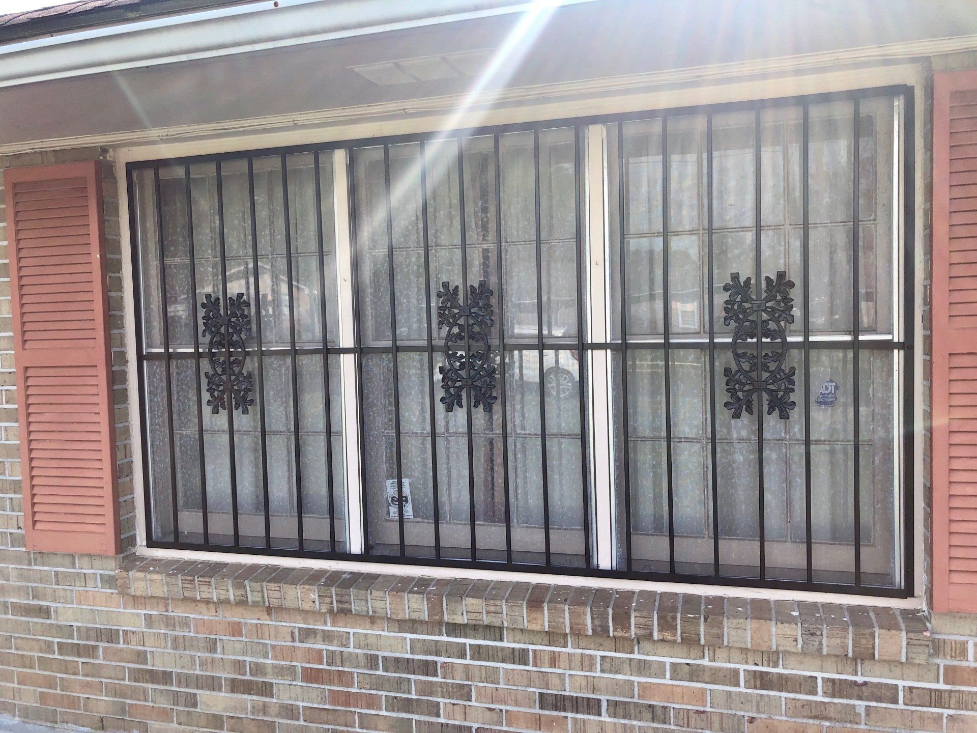 a brick building with a window with bars on it .