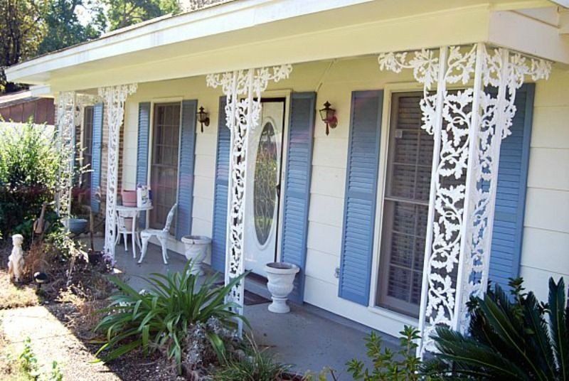 a white house with blue shutters and a porch