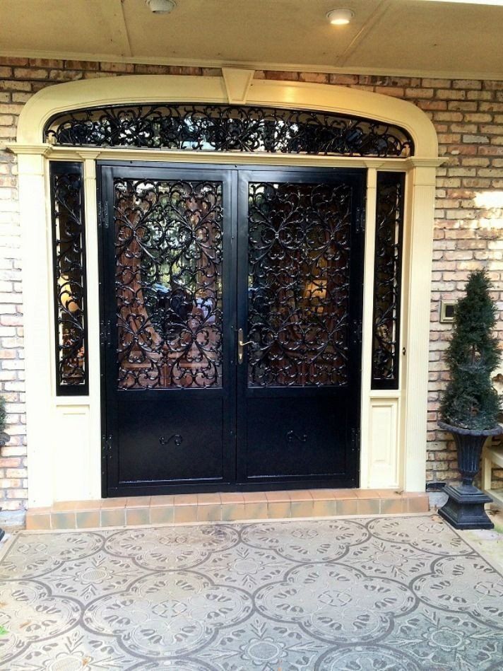 the front door of a house has a wrought iron design on it