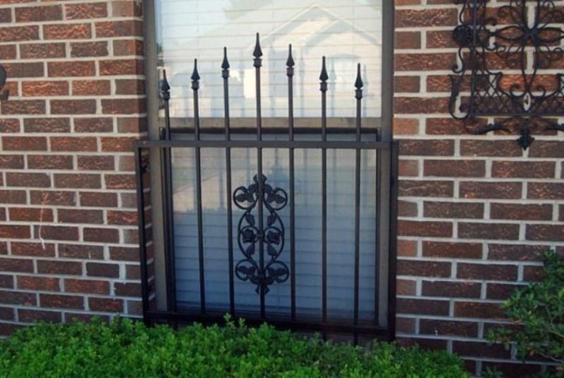 a window with a wrought iron fence around it