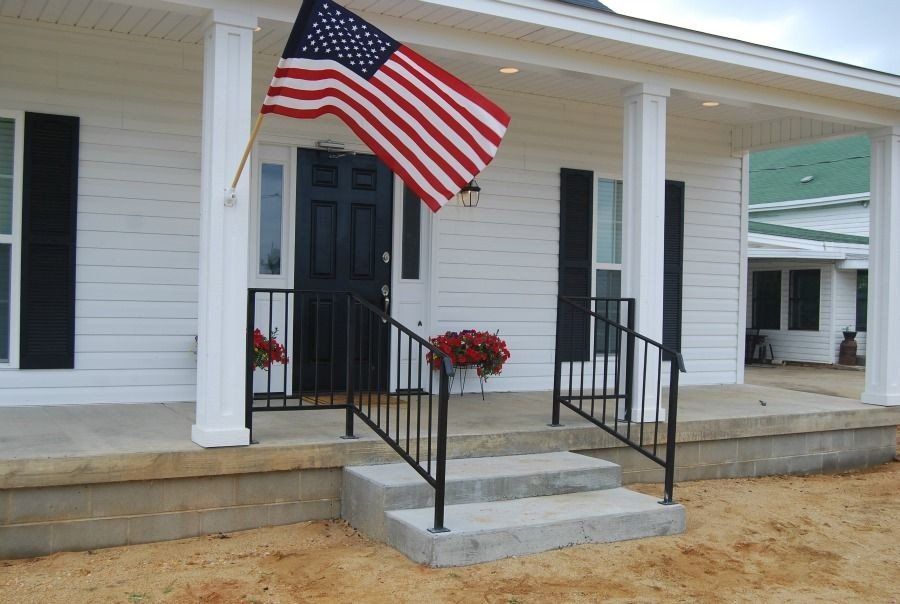 an american flag is flying in front of a white house