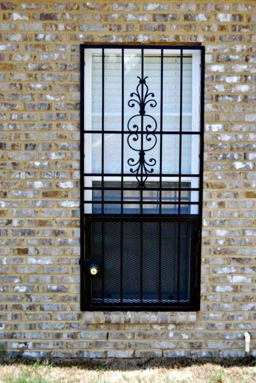 a window with a wrought iron grille on it