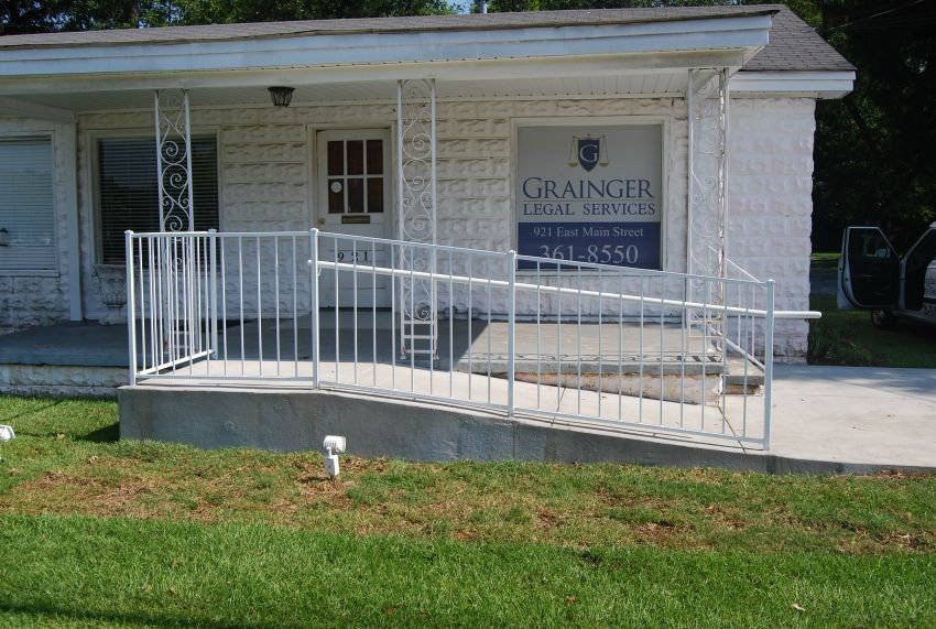 a white house with a ramp leading to the front door .