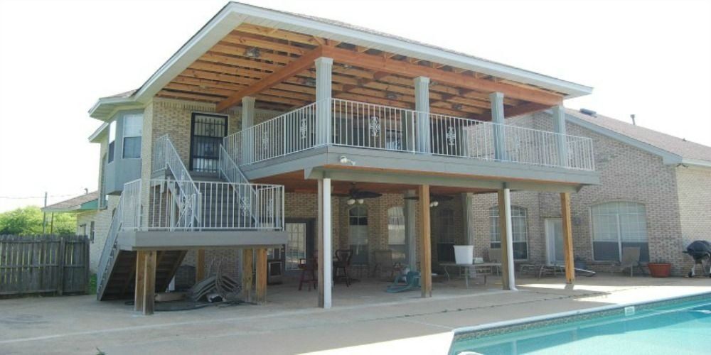 a house with a large deck and a swimming pool in the backyard .