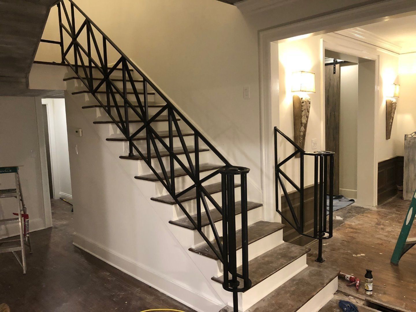 a staircase with a black railing is being built in a house .
