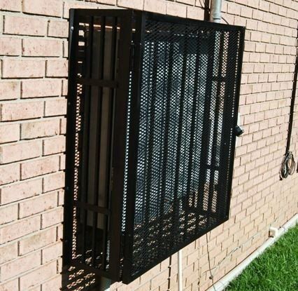 a brick wall with a metal fence on it