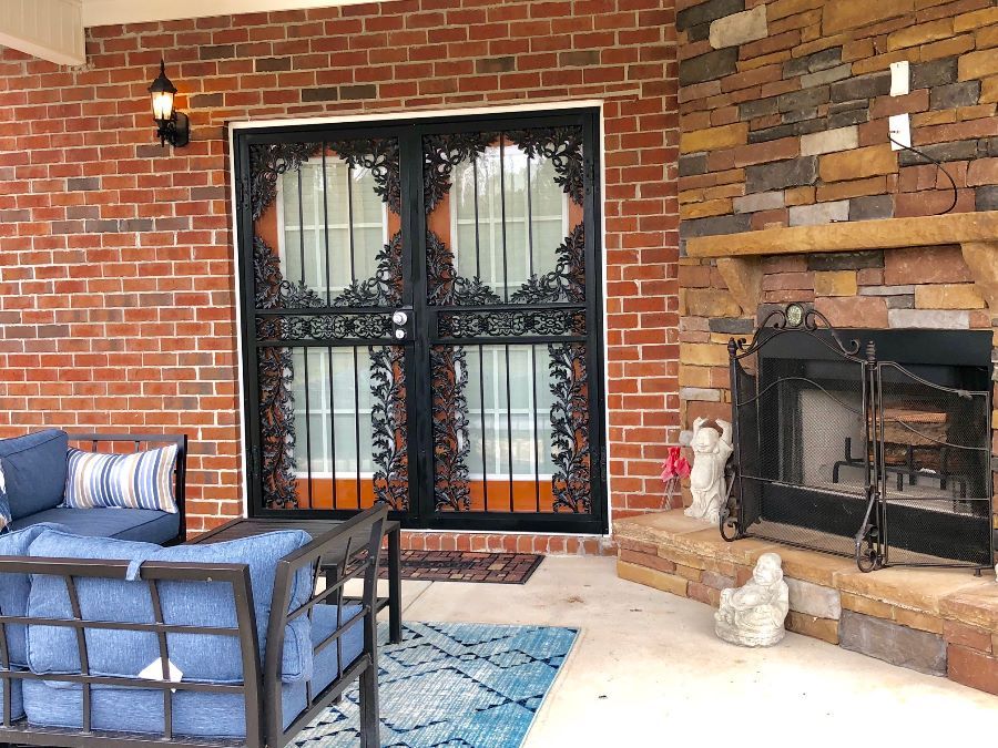 there is a fireplace and a couch on the porch .