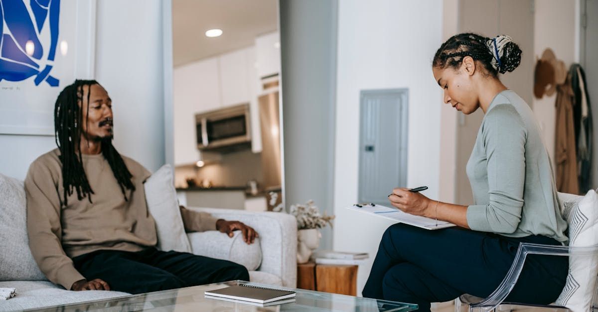 A woman is sitting on a couch during therapy for a man