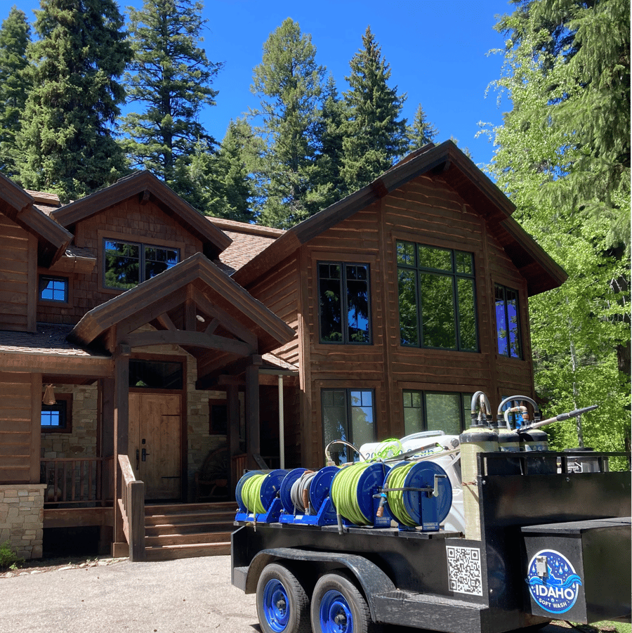 A large wooden house with a trailer parked in front of it